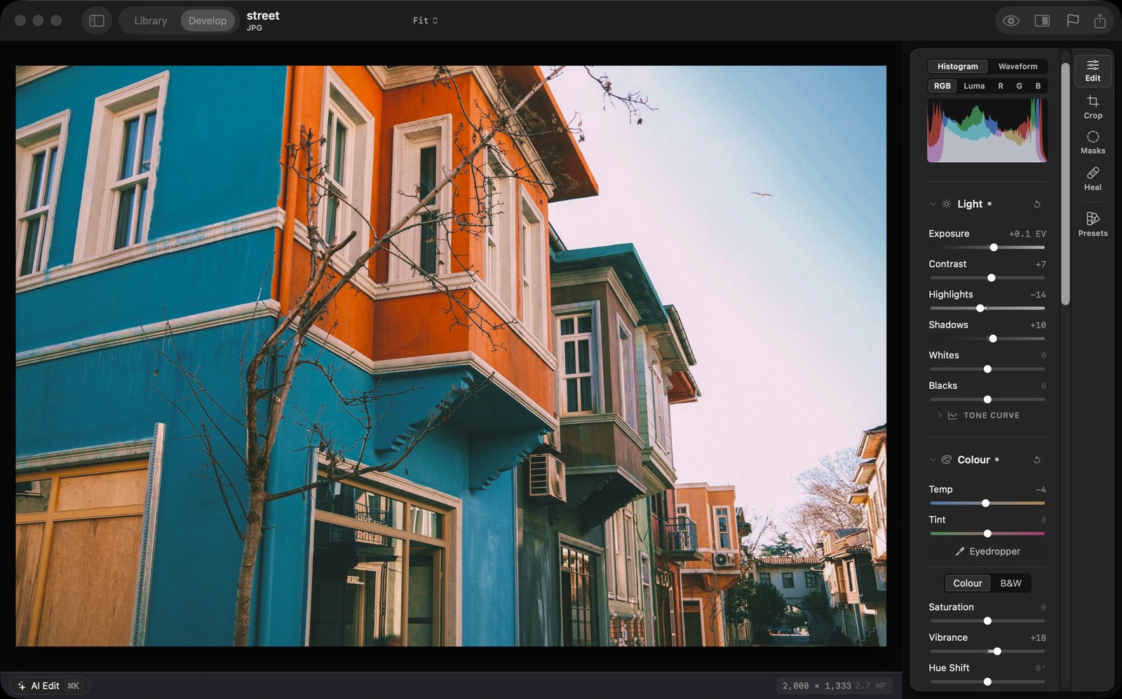 The Halumo for Mac Develop workspace, with Light and Colour controls beside a colourful street photograph.